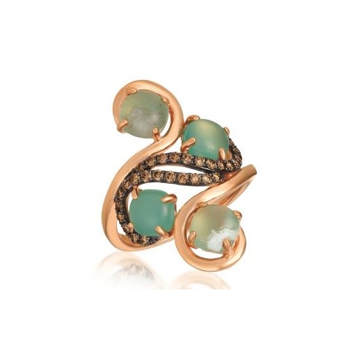A rose gold ring with green colored gem stones and chocolate diamonds